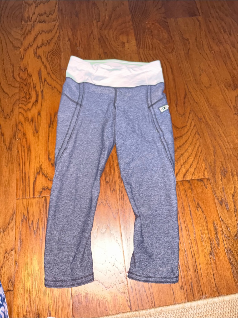 Lululemon Capri leggings in Heather Gray with pale green/yellow waist band